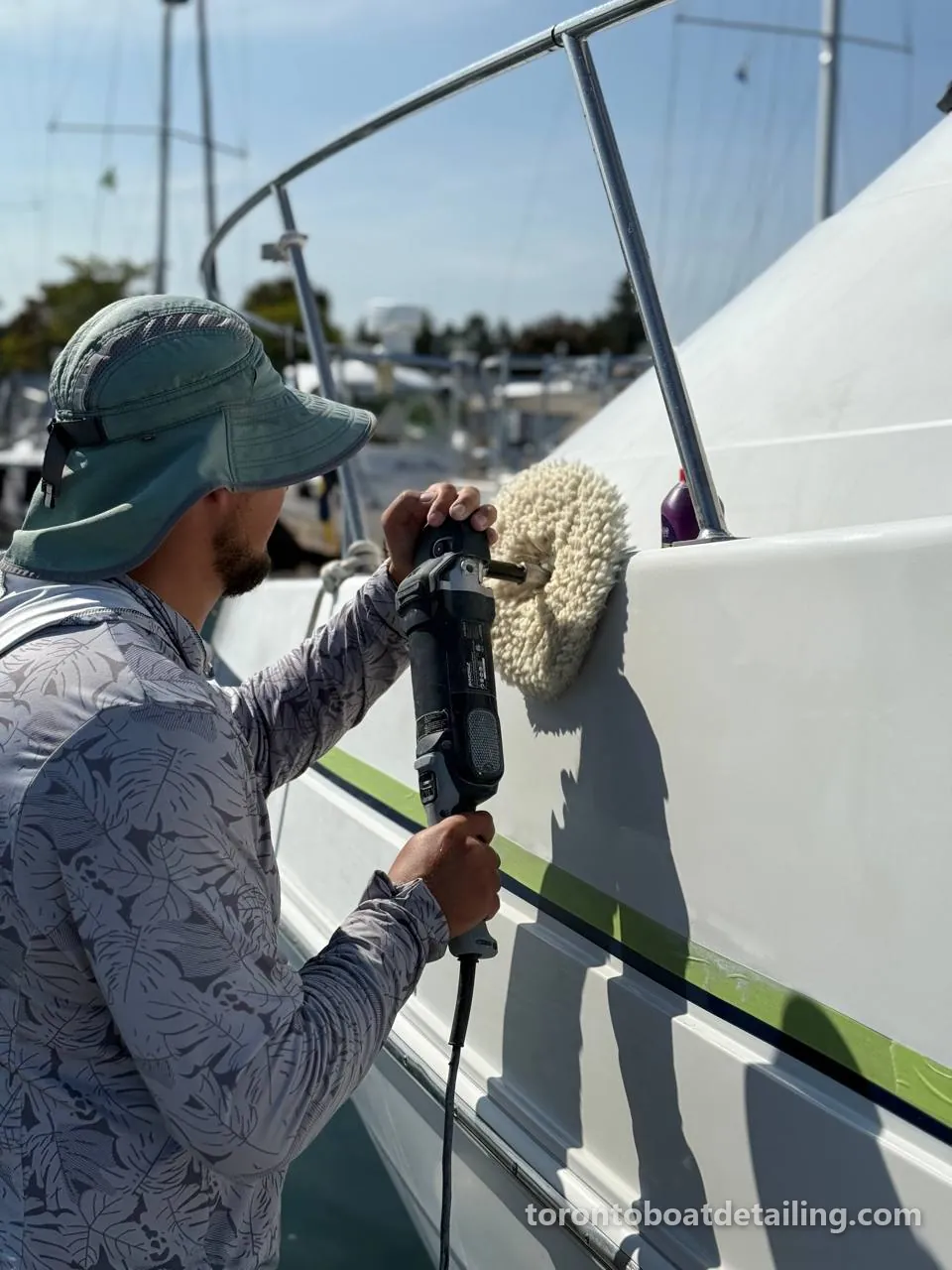 Crew machine-polishing a hull